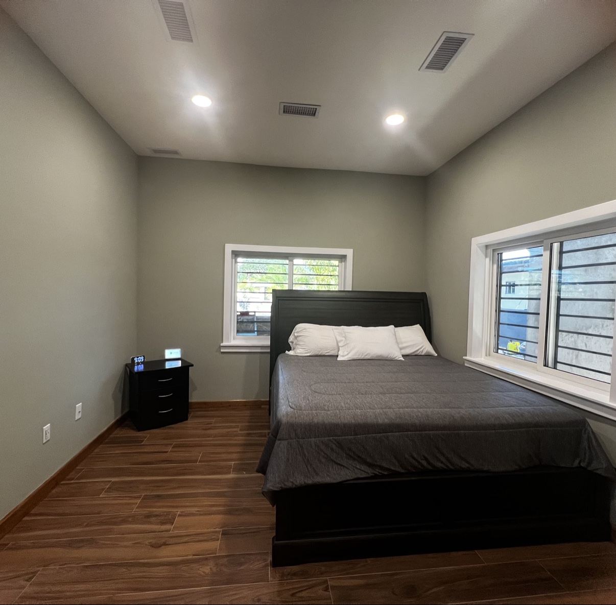 Paradise Palms bedroom with a large bed, wood-look floors and windows