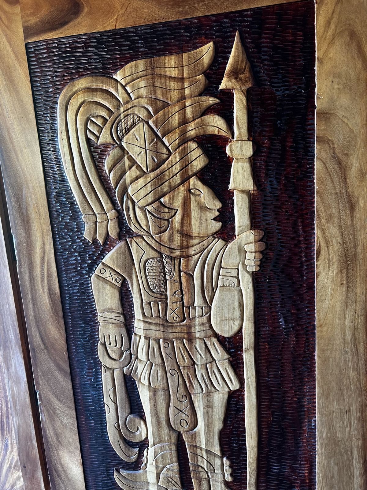 Carved wooden Mayan-style wall art at Paradise Palms